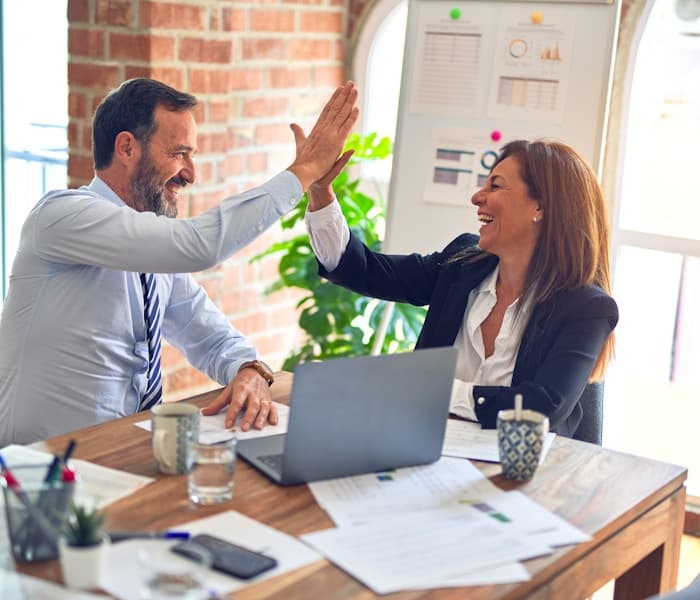 Partners celebrating a successful referral
